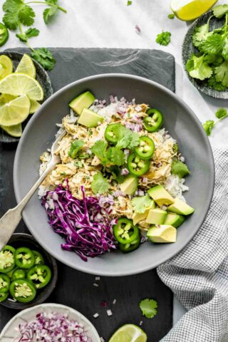 a serving idea: rice bowl with the shredded green chile chicken on top plus toppings