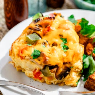 a serving of the casserole on a white dish with home fries