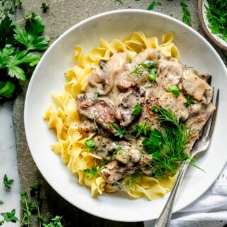 stroganoff on noodles with sprigs of dill