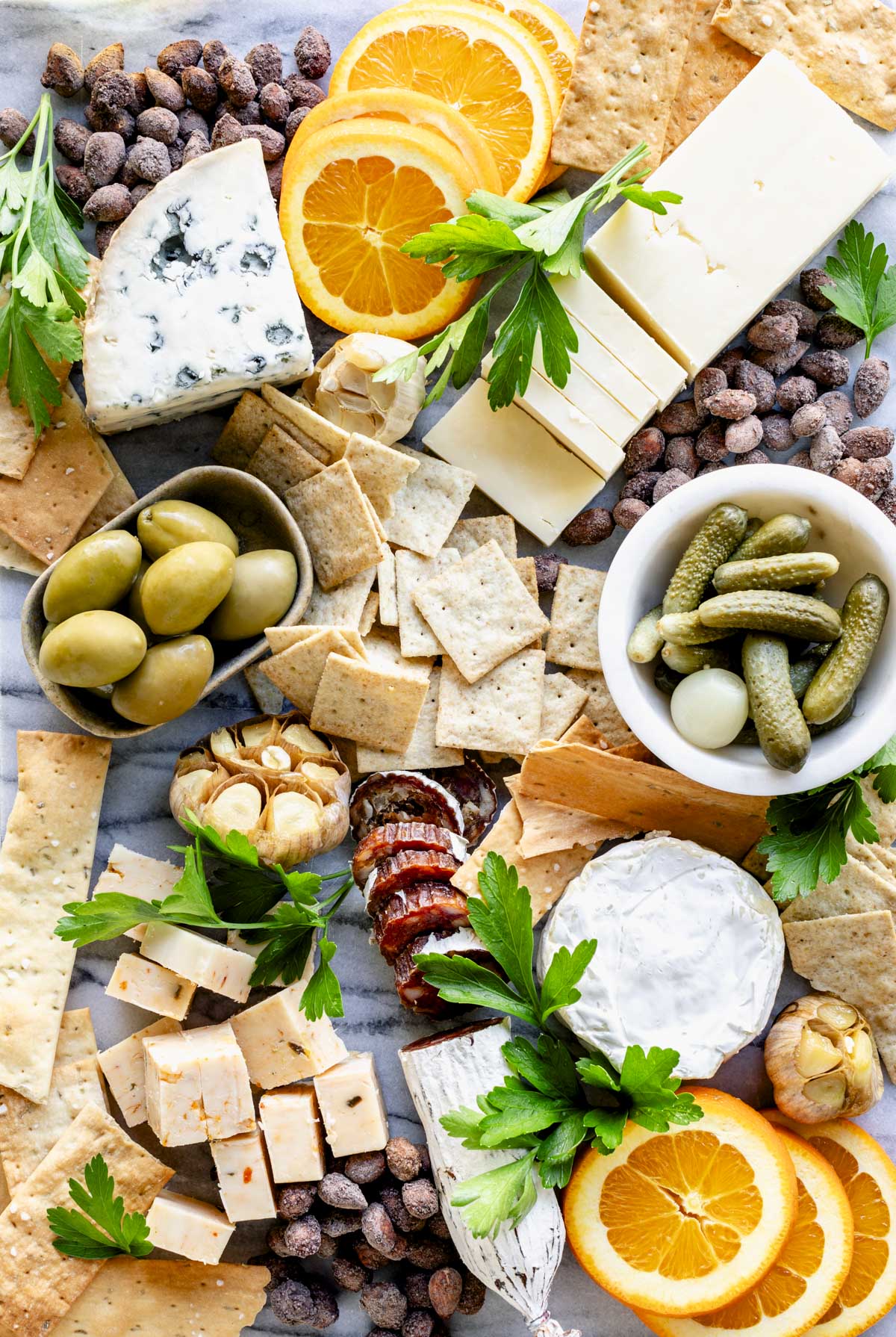 a cheese board with blue cheese, cheddar, roasted garlic and cornies